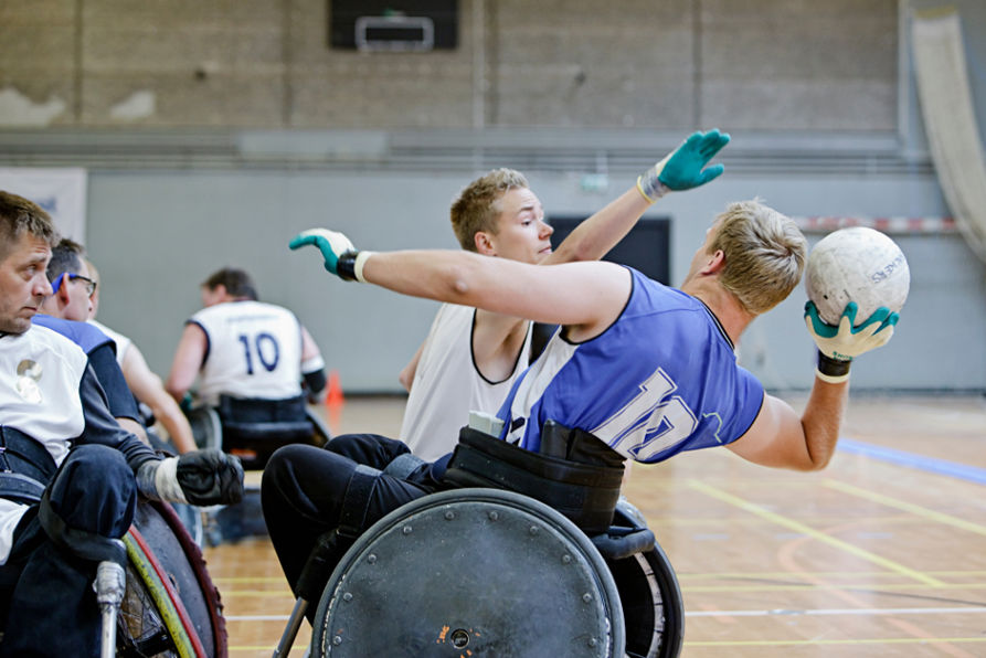 Increased Social and Community Participation - Men in wheelchairs playing pararugby 