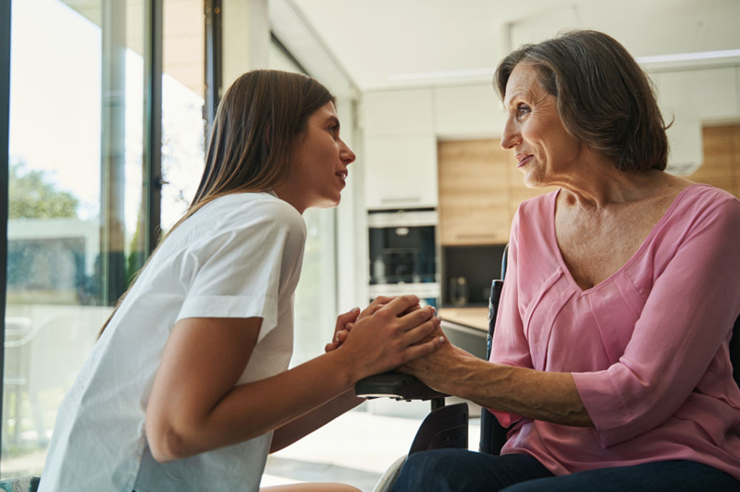 NDIS House hold support lady holding hand of lady with disability